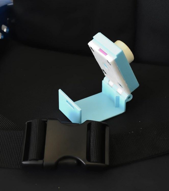 Wheelchair seat belt buckle locking device